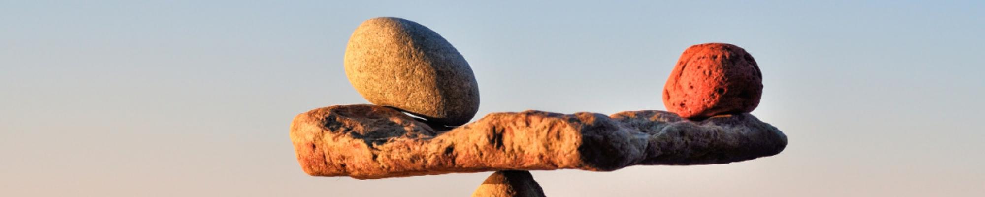 Image shows several rocks balancing on each other